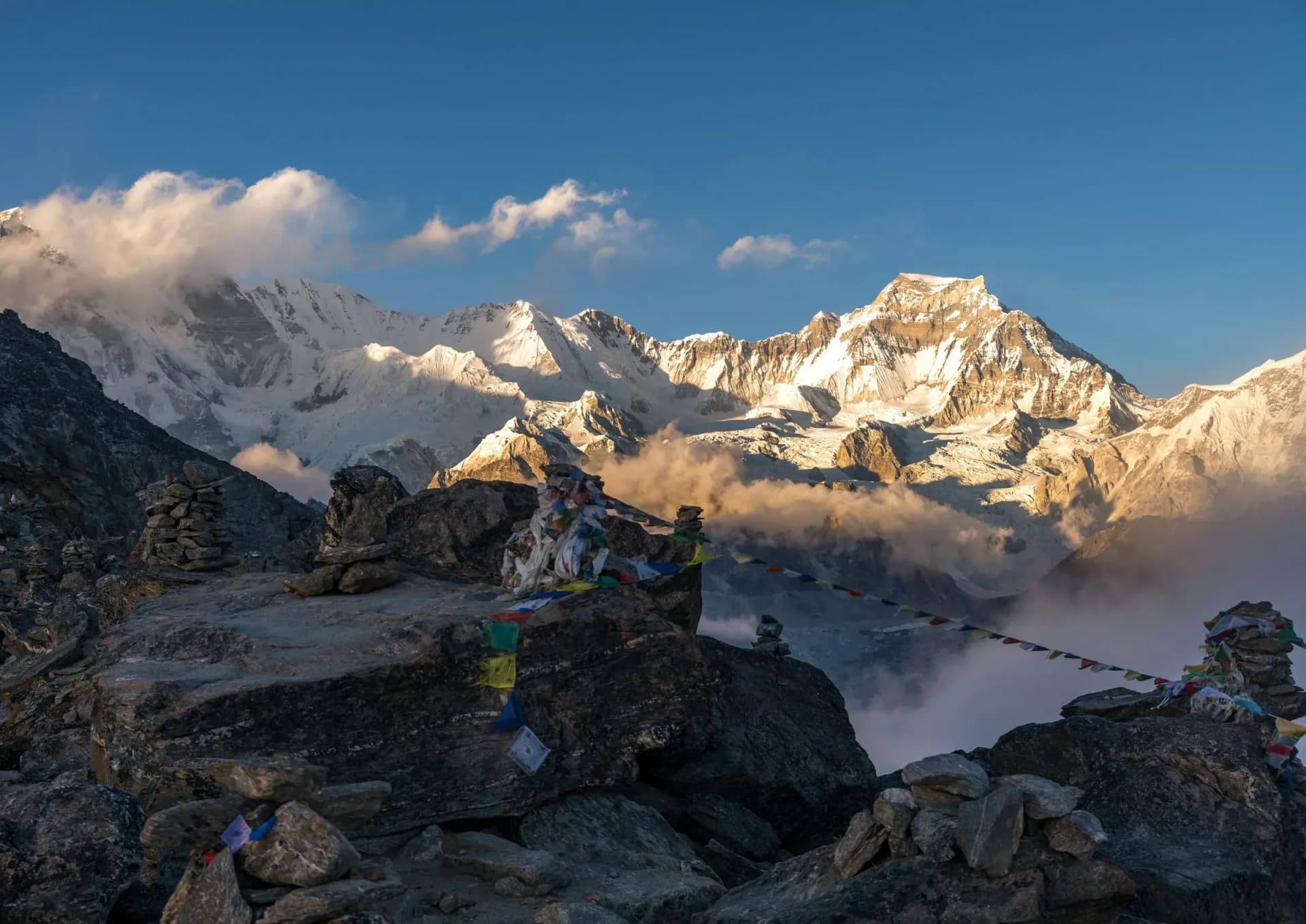 Prayer flags and Himalayan peaks in golden evening light