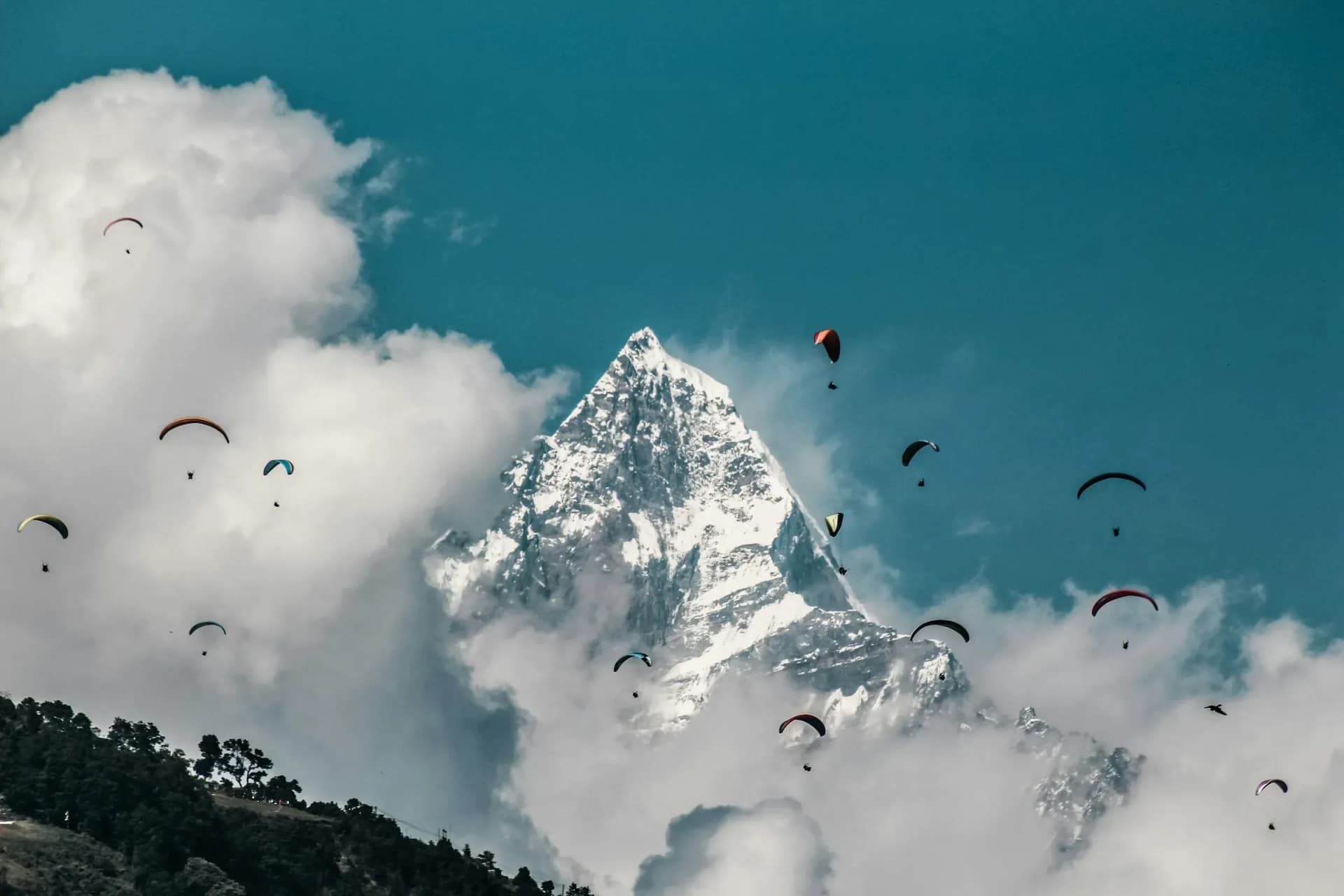 Paragliders drifting below Machapuchare above Pokhara