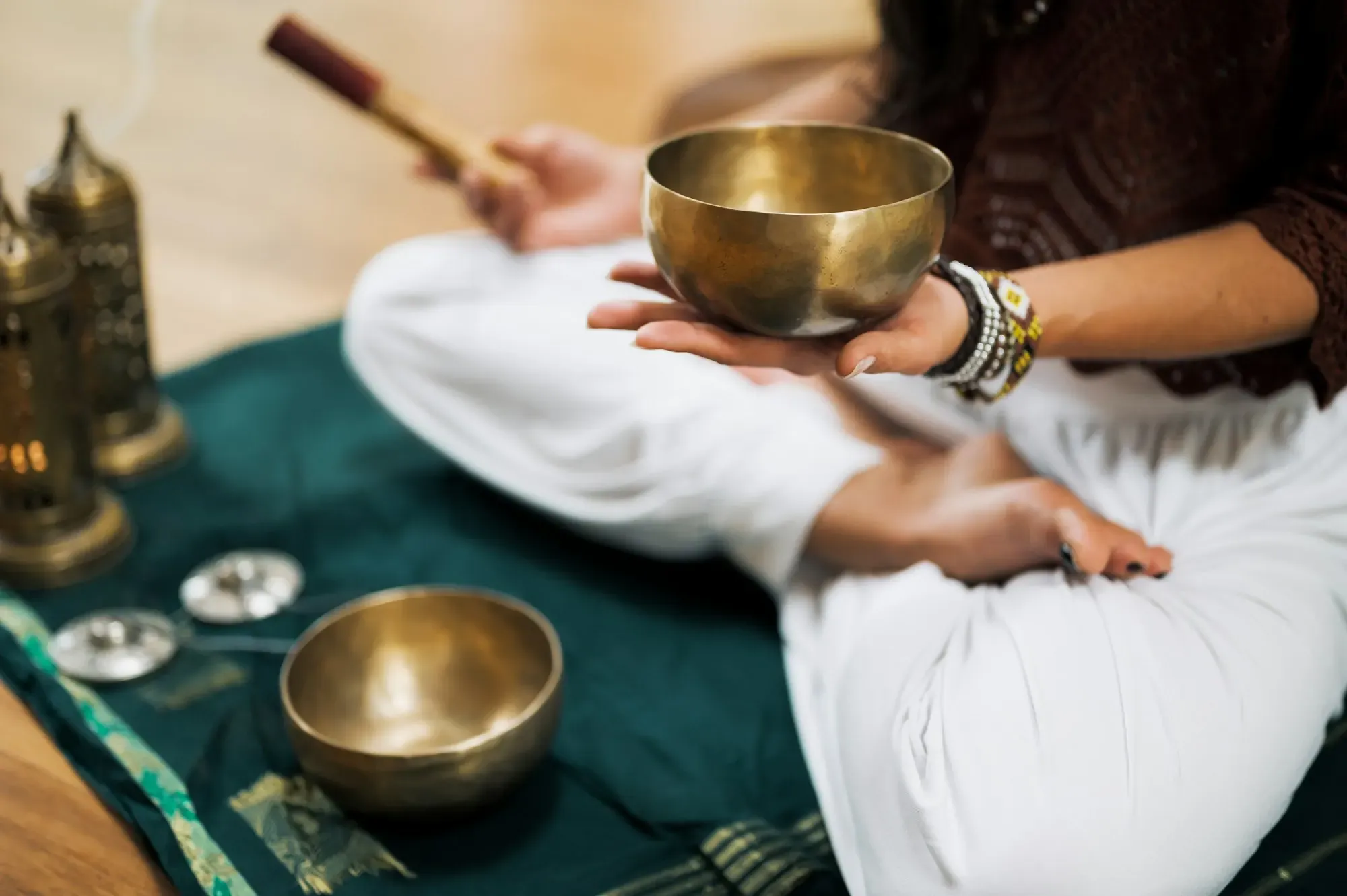 Hands holding a brass singing bowl during a quiet meditation