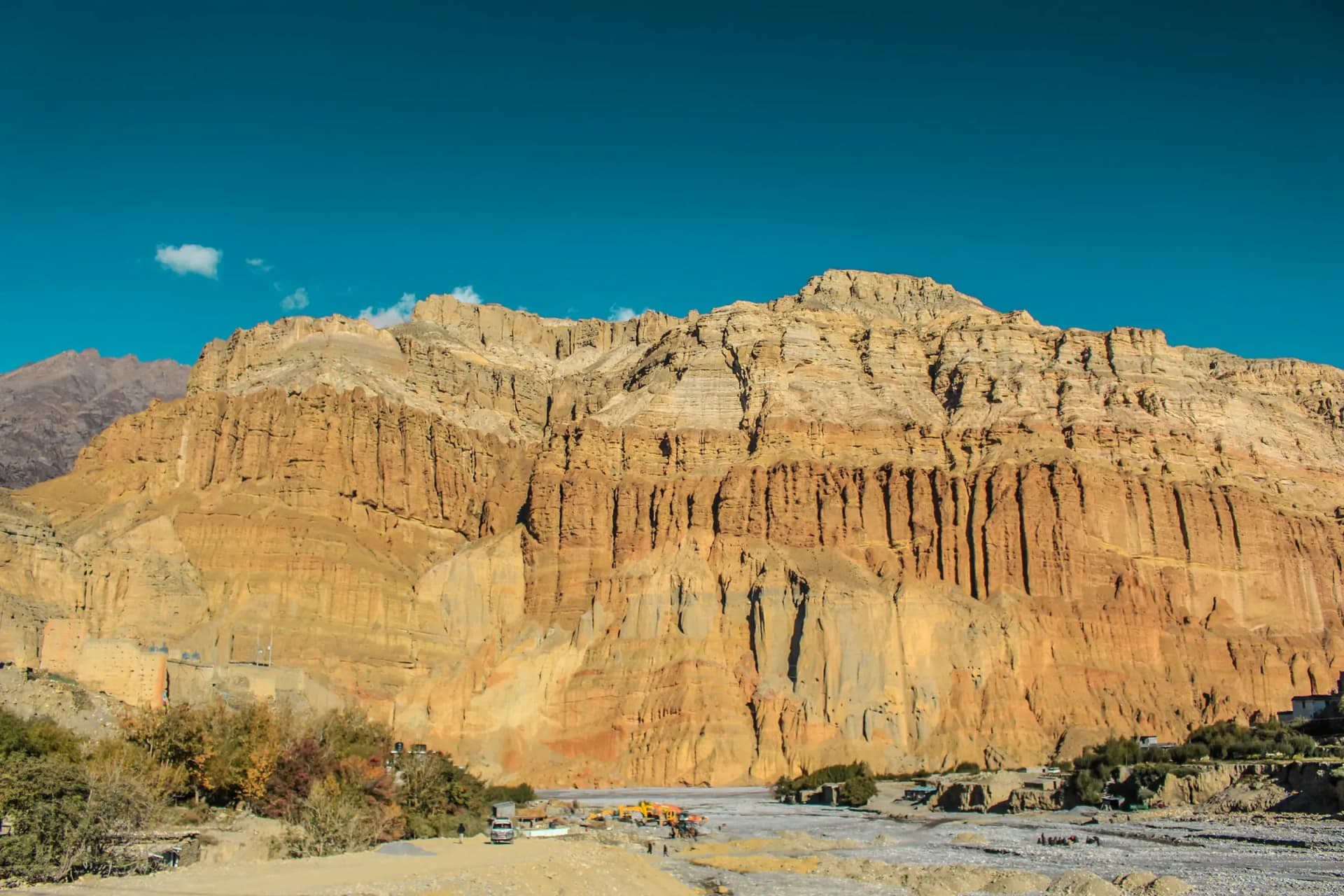 The towering red cliffs of Upper Mustang under a deep blue sky