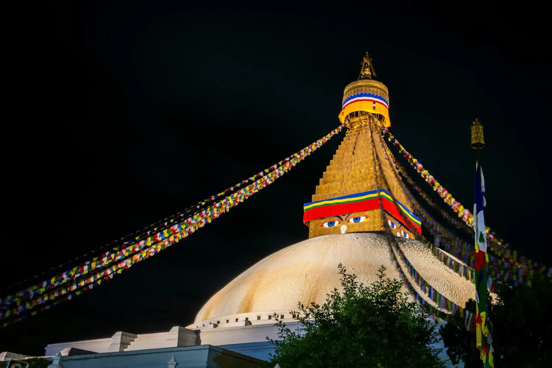Boudhanath Stupa lit up at night with prayer flags, Kathmandu