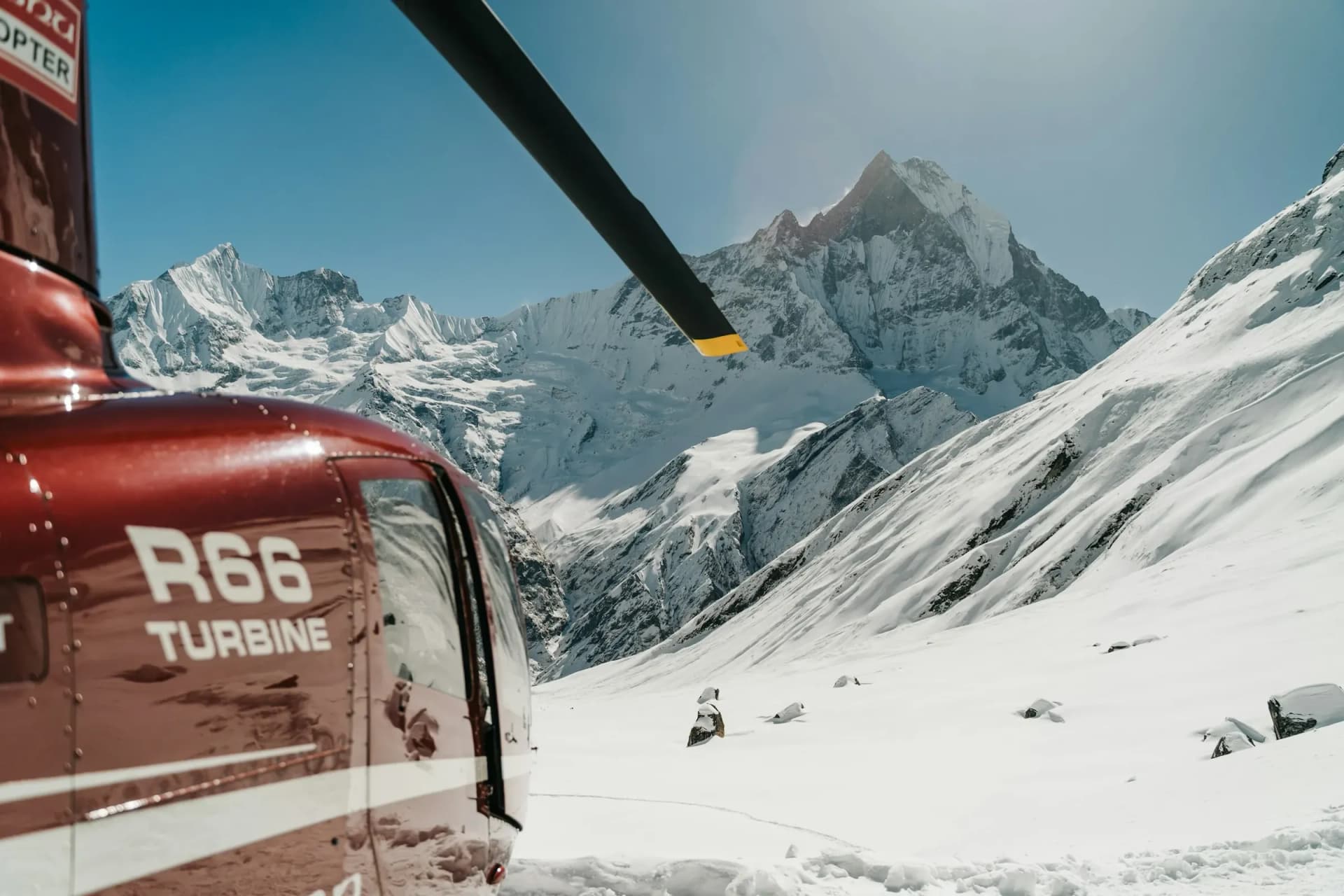 Helicopter at Annapurna Base Camp beneath Machapuchare